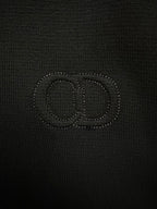 Black knit jacket with stitched logo on the chest