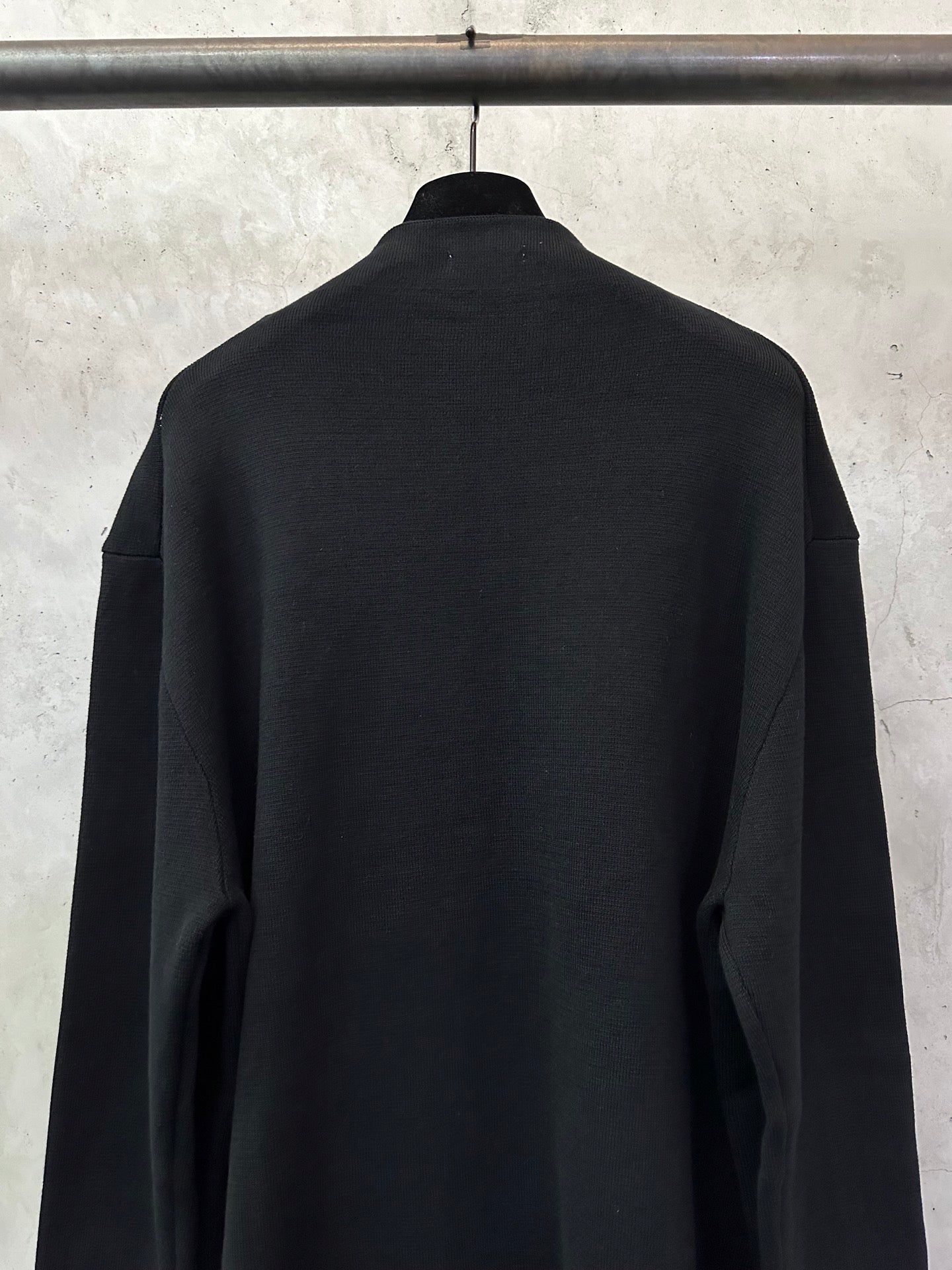 Black zip-up jacket, back view with high neckline