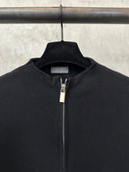 Black knit zip-up jacket with metal zipper and stand collar