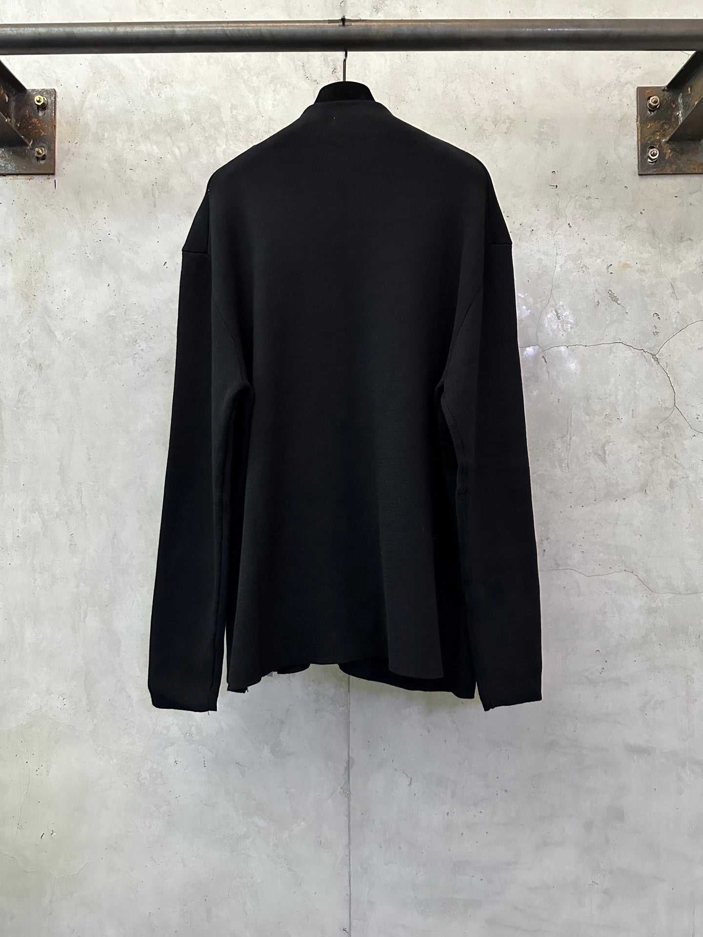 Black zip-up jacket, back view, long sleeves