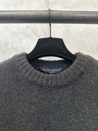 Dark charcoal knit sweater neckline with Louis Vuitton brand label