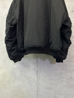 Black bomber jacket back view with ribbed hem and gathered sleeve cuffs
