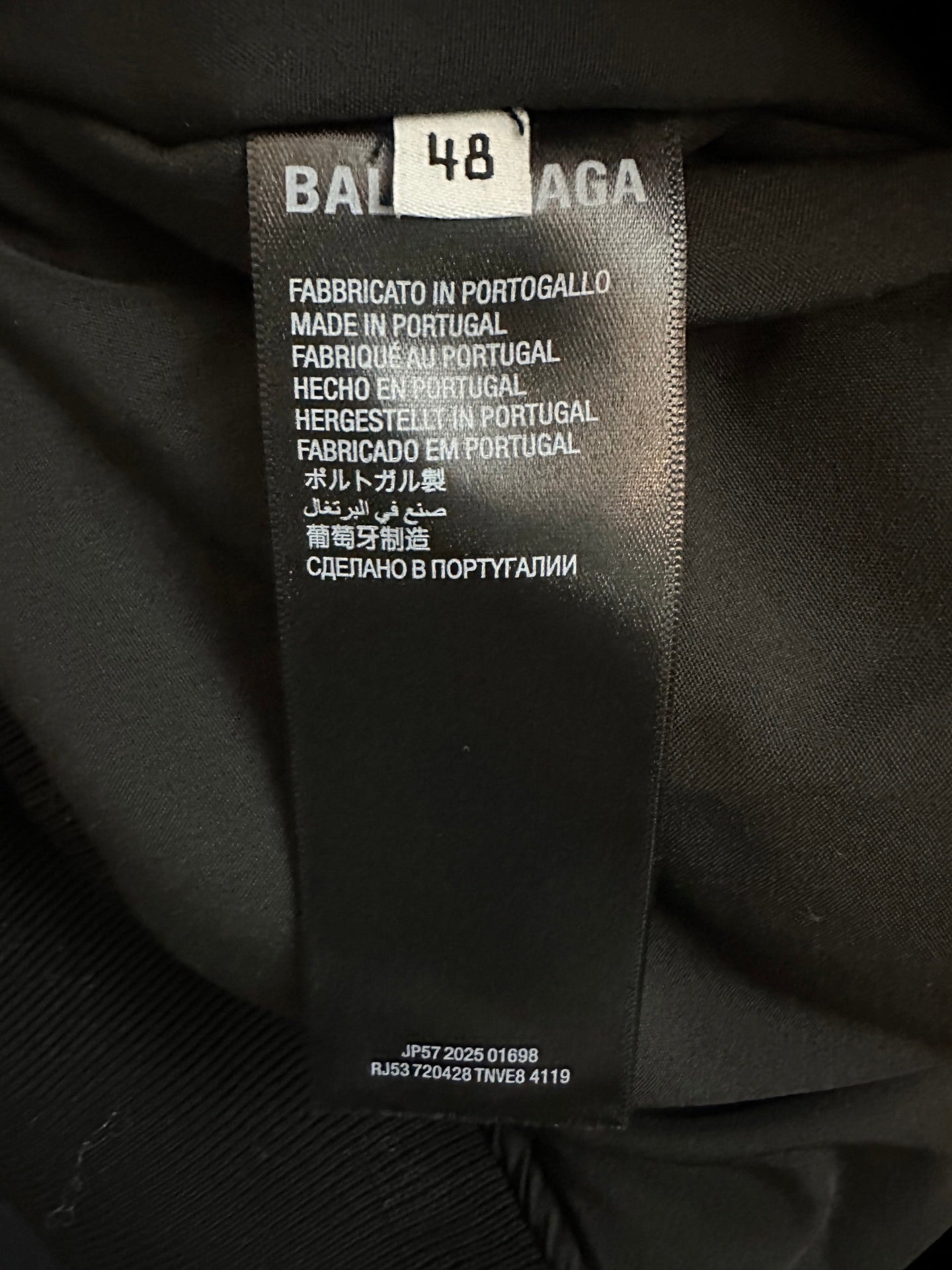 Black fabric care label with size 48 and BALENCIAGA branding