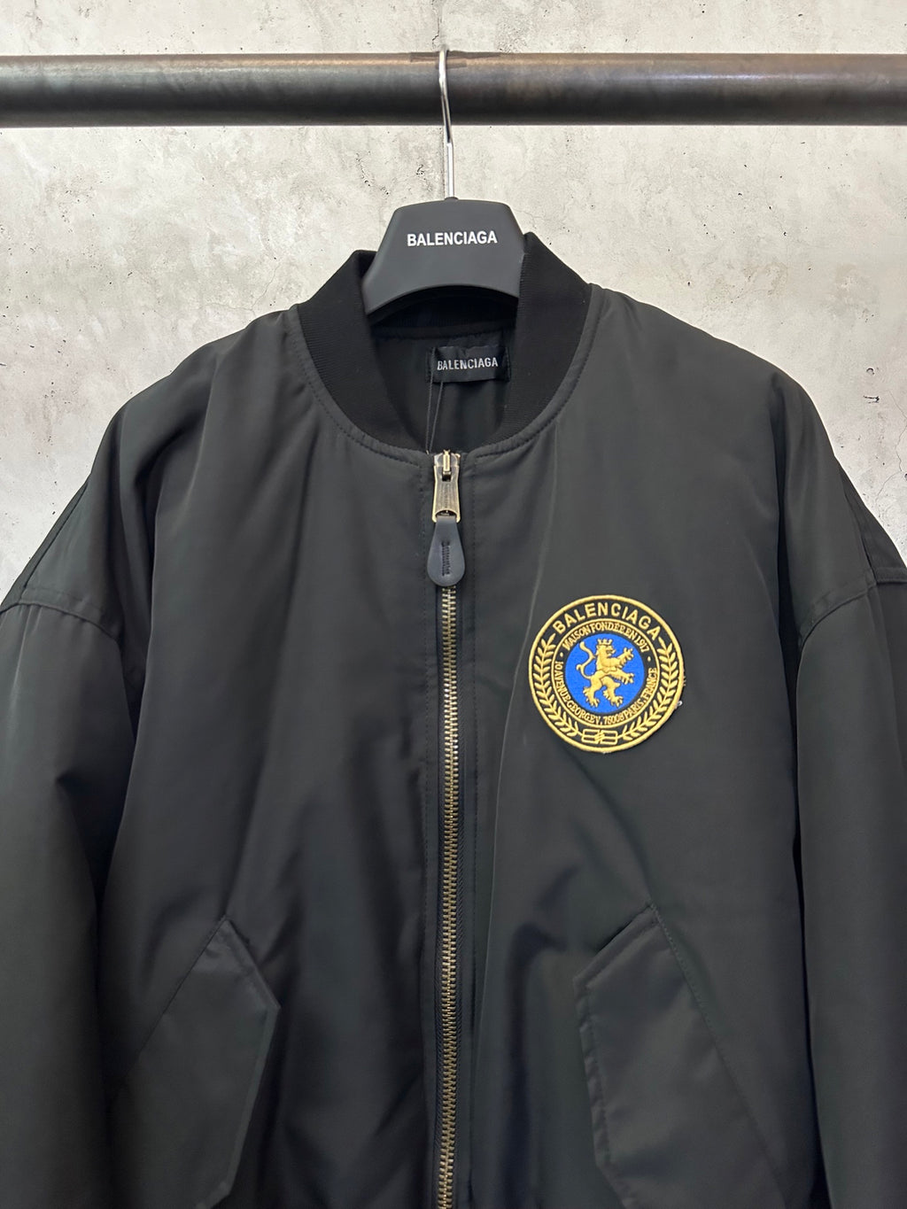 Black bomber jacket with zip placket and BALENCIAGA crest patch