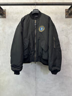 Black bomber jacket with zip front and BALENCIAGA crest patch on chest
