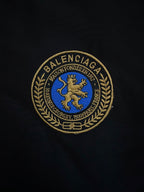 BALENCIAGA gold-and-blue crest patch embroidered on black fabric