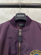 Purple bomber jacket neck with Balenciaga logo label and gold-tone zipper pull