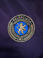 Embroidered crest logo patch on purple bomber jacket with blue lion