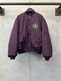 Purple zip-up bomber jacket with front crest logo patch and stand collar