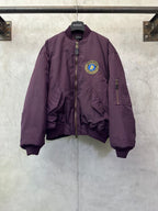 Purple zip-up bomber jacket with front crest logo patch and stand collar