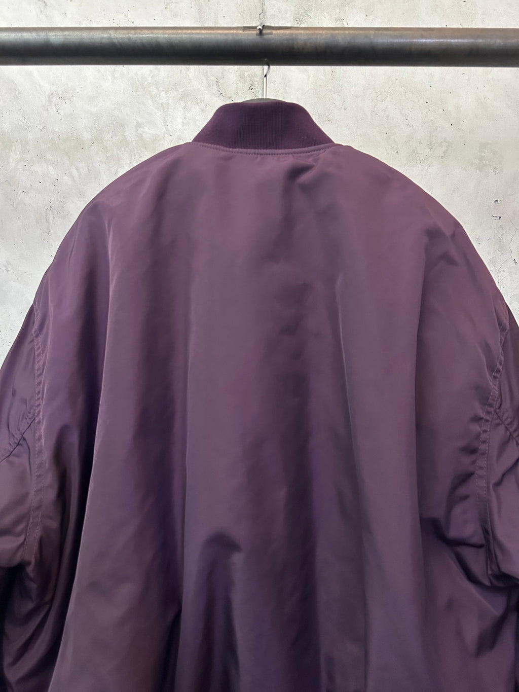 Purple bomber jacket back with stand collar and seam detailing at shoulders