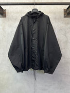 Black hooded jacket with button front and drawstring hem, long sleeves