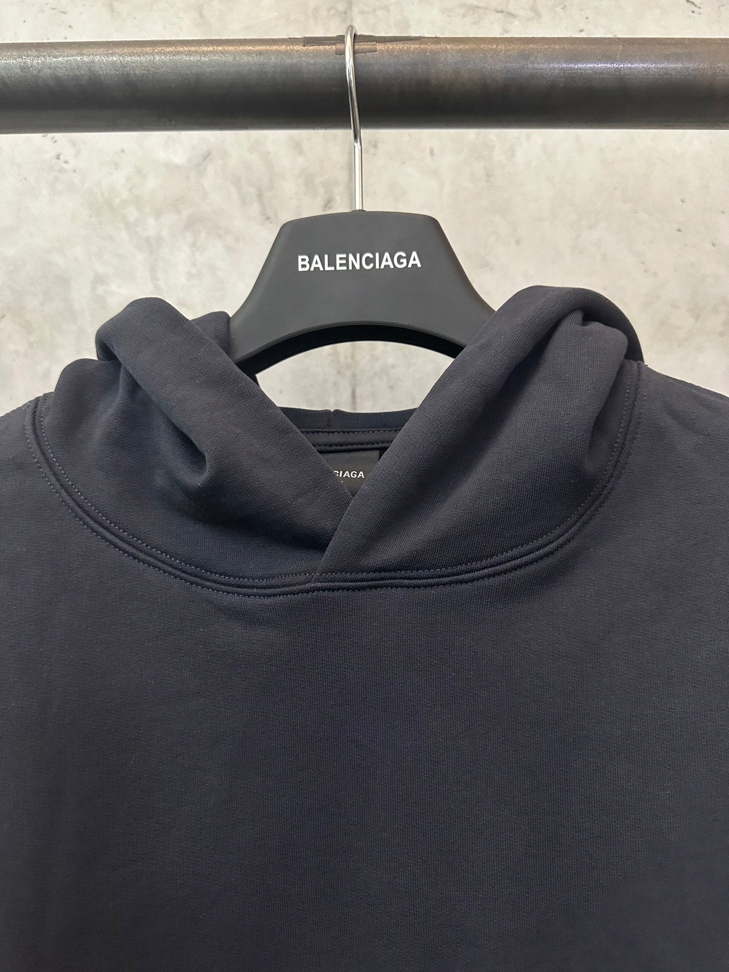 Black hoodie cowl neck with ribbed neckline, hanging Balenciaga tag