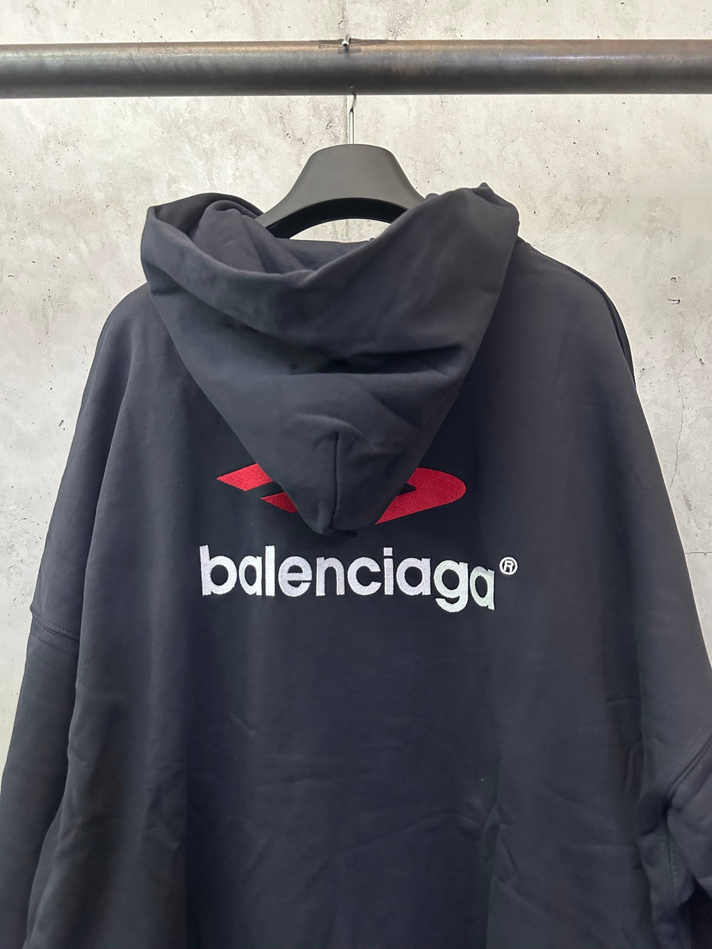 Black hoodie with red Balenciaga back logo, cowl hood and long sleeves