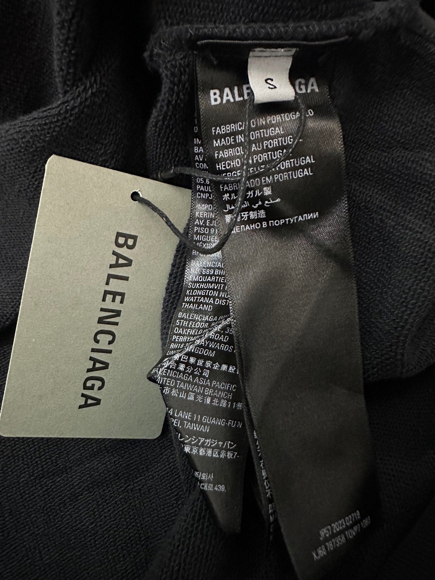 Black hoodie interior care tag with Balenciaga label and product details