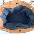YSL tan tote interior with blue lining, inner pocket, and gold hardware buttons