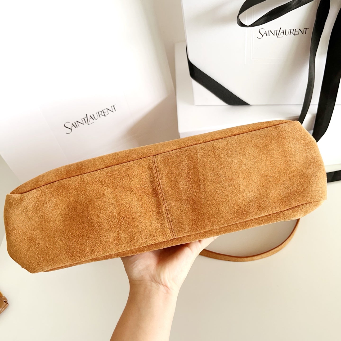 YSL suede pouch bag in tan with rounded top and stitched seams