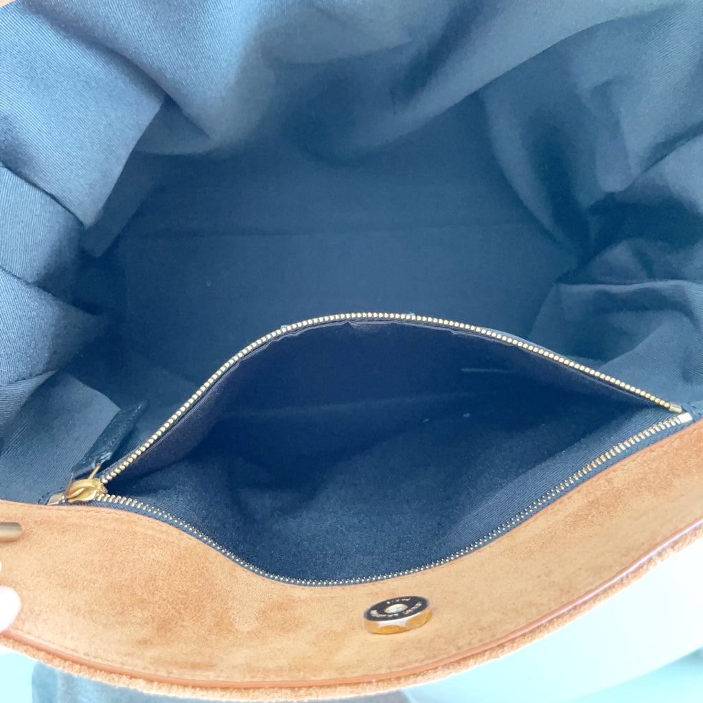 YSL tan bag interior with blue lining and zip track, showing gold chain hardware