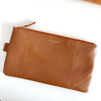 YSL tan leather pouch with zip top, diagonal stitching, and small logo embossing