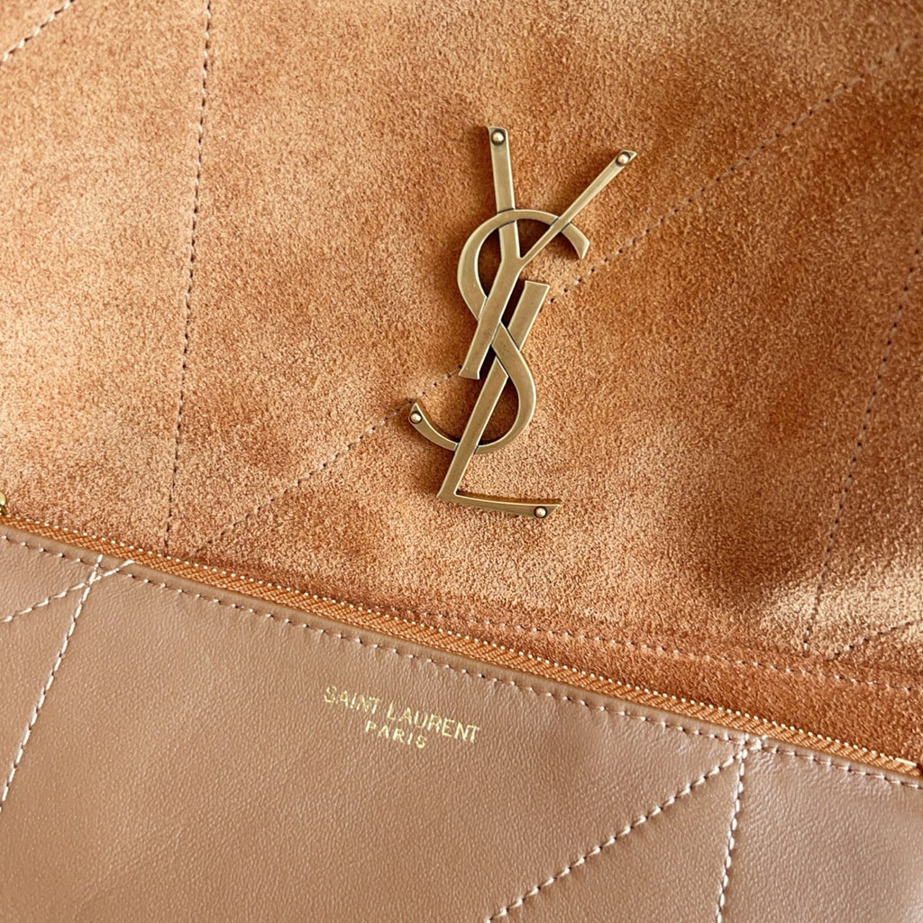 YSL suede pouch close-up with stitched trim and metal YSL logo hardware
