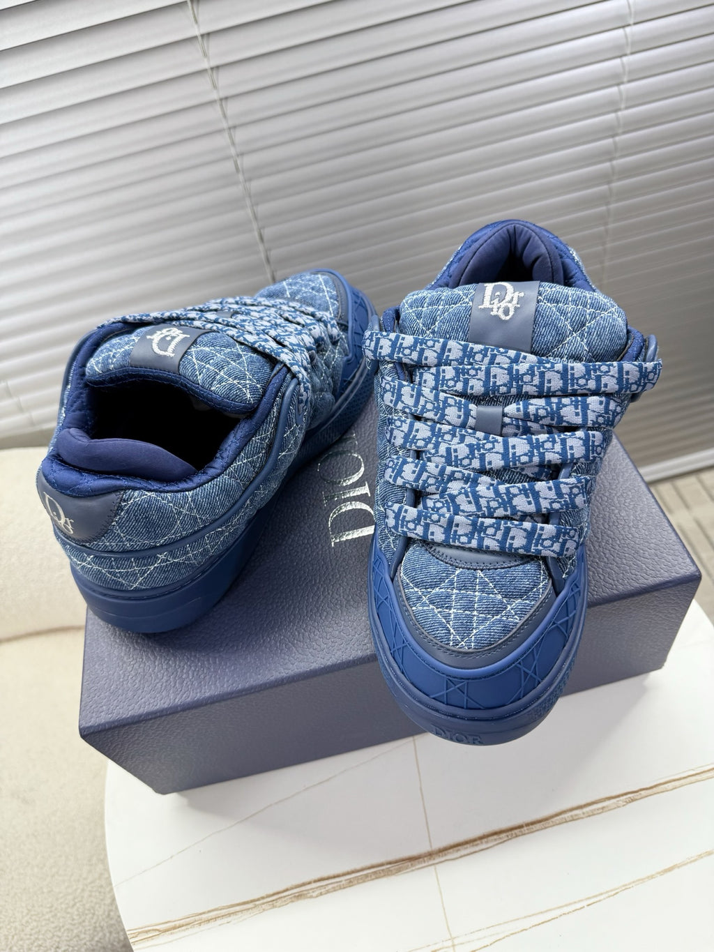 Blue unisex Dior sneakers, pair view with high strap and quilted logo print
