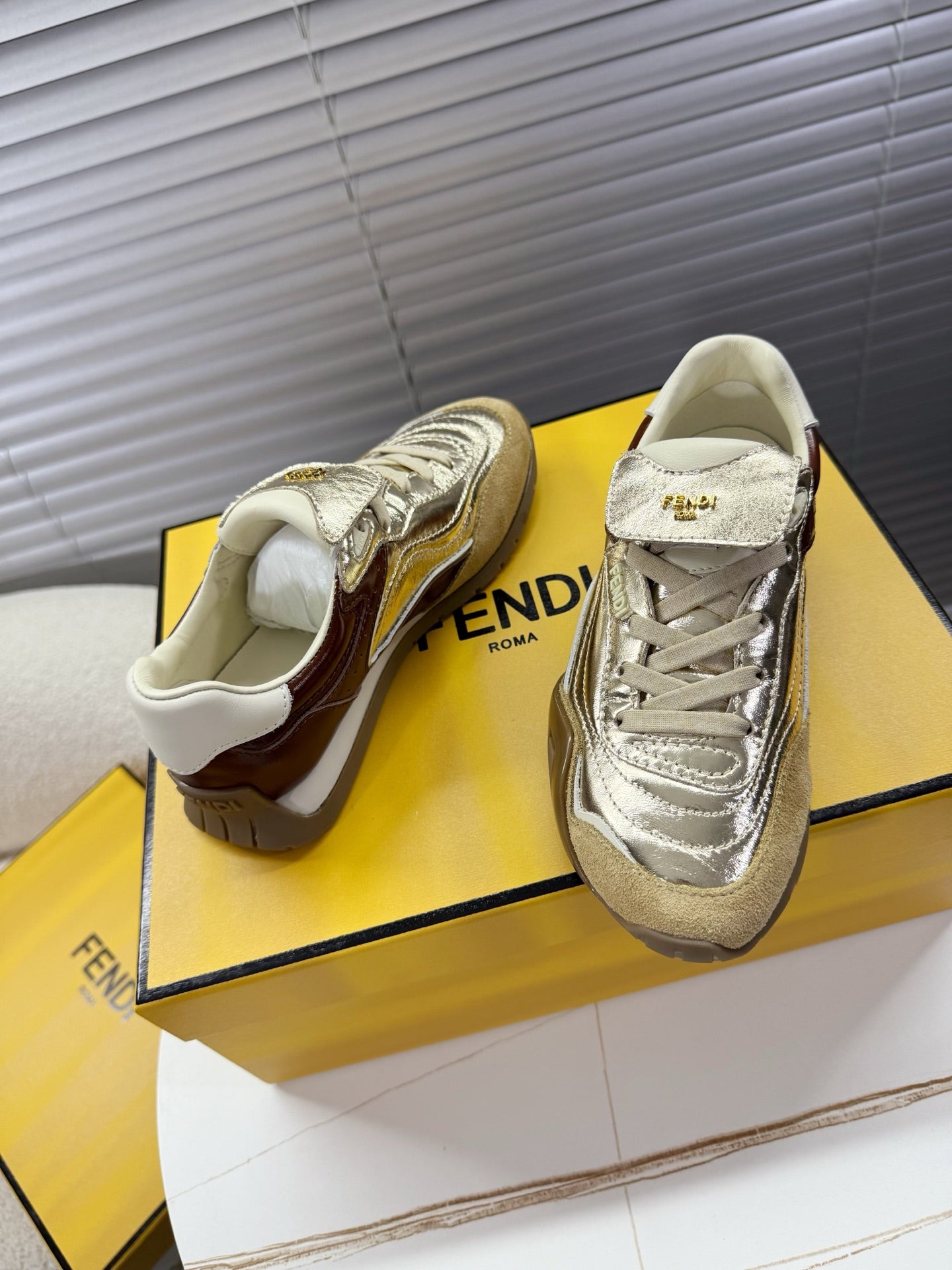 Fendi unisex luxury sneakers, metallic silver uppers with cream lining and laces