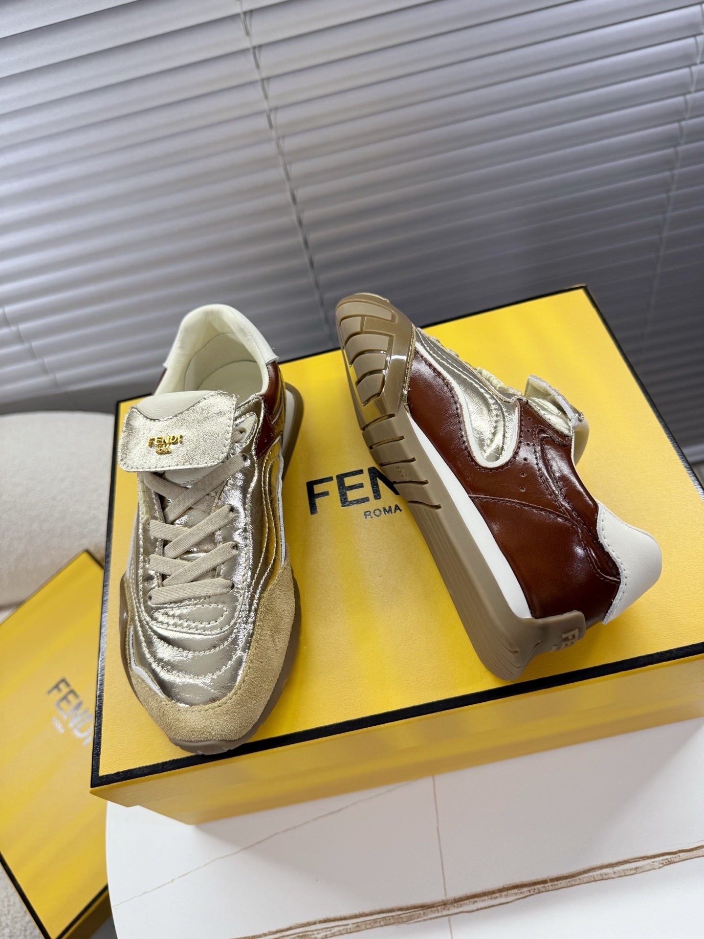 Fendi unisex luxury sneakers pair, metallic silver and brown leather side panels