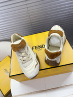 White low-top sneakers with brown suede heel tab and visible tongue label