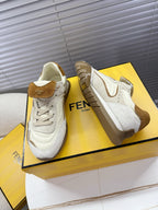 White low-top sneakers with brown suede trim, lace-up front, and FENDI Roma logo