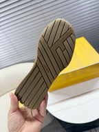 Brown sneaker outsole with tread pattern and Fendi branding on heel