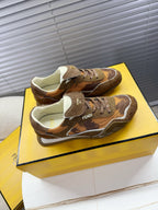 Brown lace-up low-top sneakers with layered panels and cream lining inside