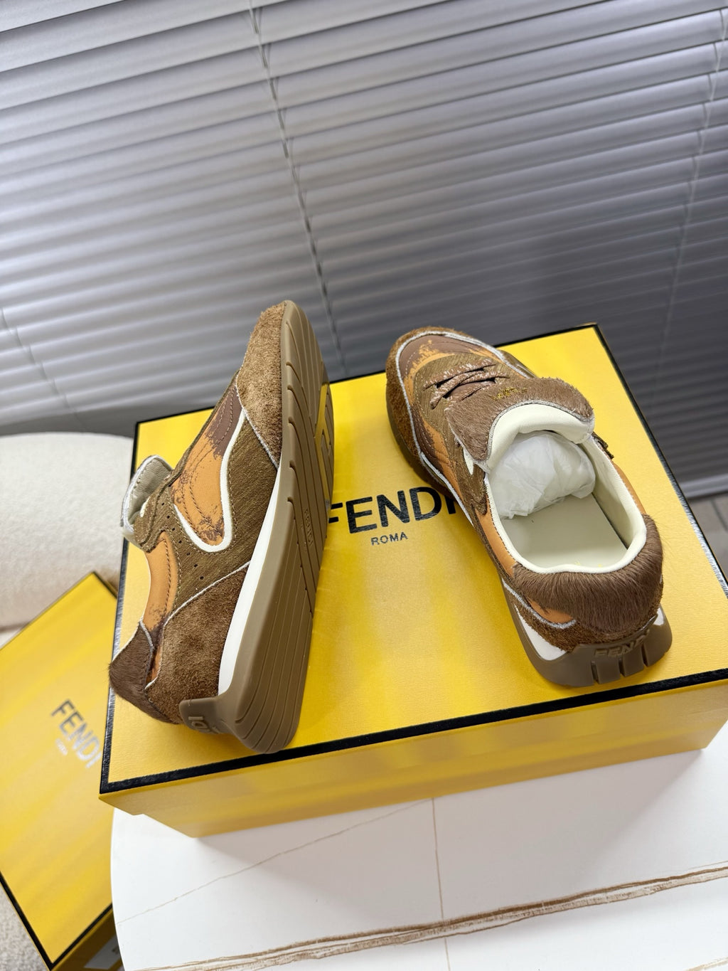 Brown lace-up low-top sneakers shown from front and back, with white side swoop