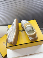Light gray Fendi sneakers side view with tan trim and lace-up upper