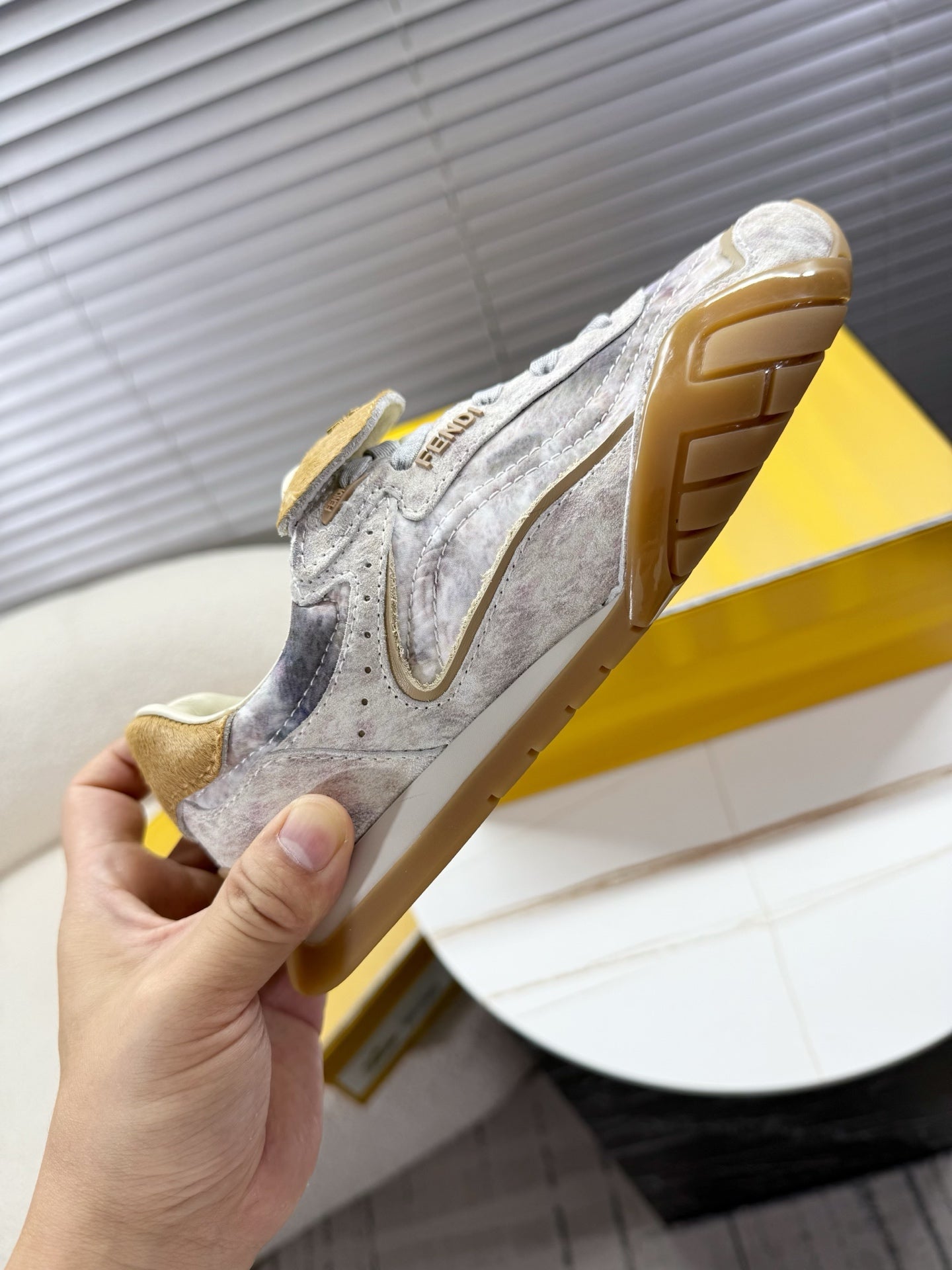 Light gray Fendi sneaker with tan sole edge and lateral side detail