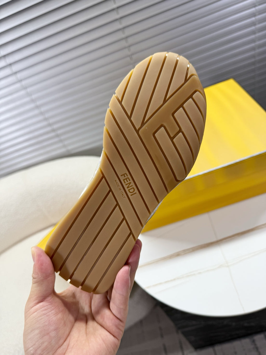 Brown sneaker outsole with striped rubber tread pattern