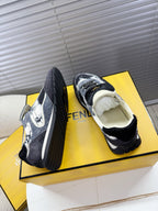 Fendi lace-up sneakers with black and white splatter, cream lining, angled heel view.