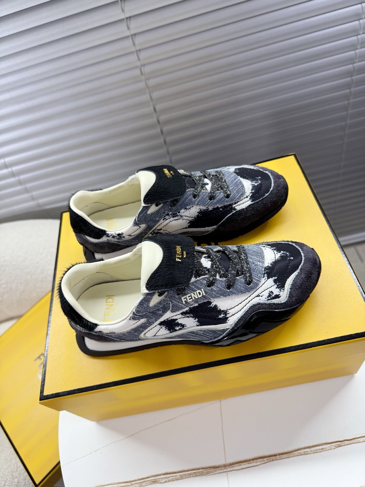 Fendi unisex low-top sneakers, top view with dark denim and white speckled uppers