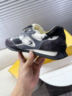 Fendi unisex sneaker close-up, white and dark speckled upper with rubber sole