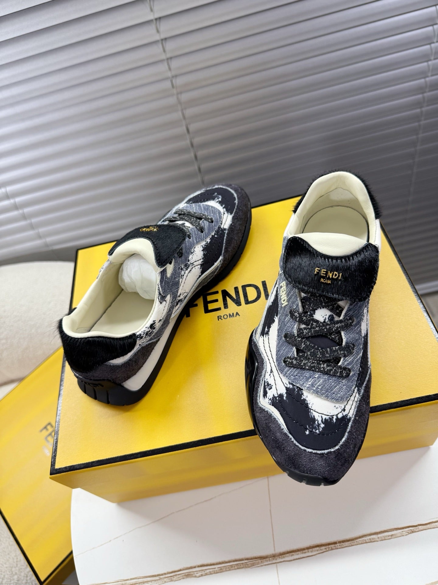 Fendi lace-up sneakers, black and white splatter uppers, cream lining, front and side.