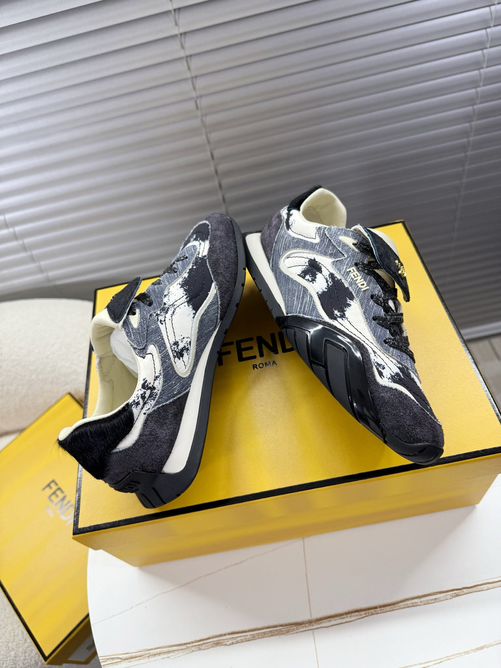 Fendi unisex sneakers, angled pair with dark fabric, white speckled pattern and laces