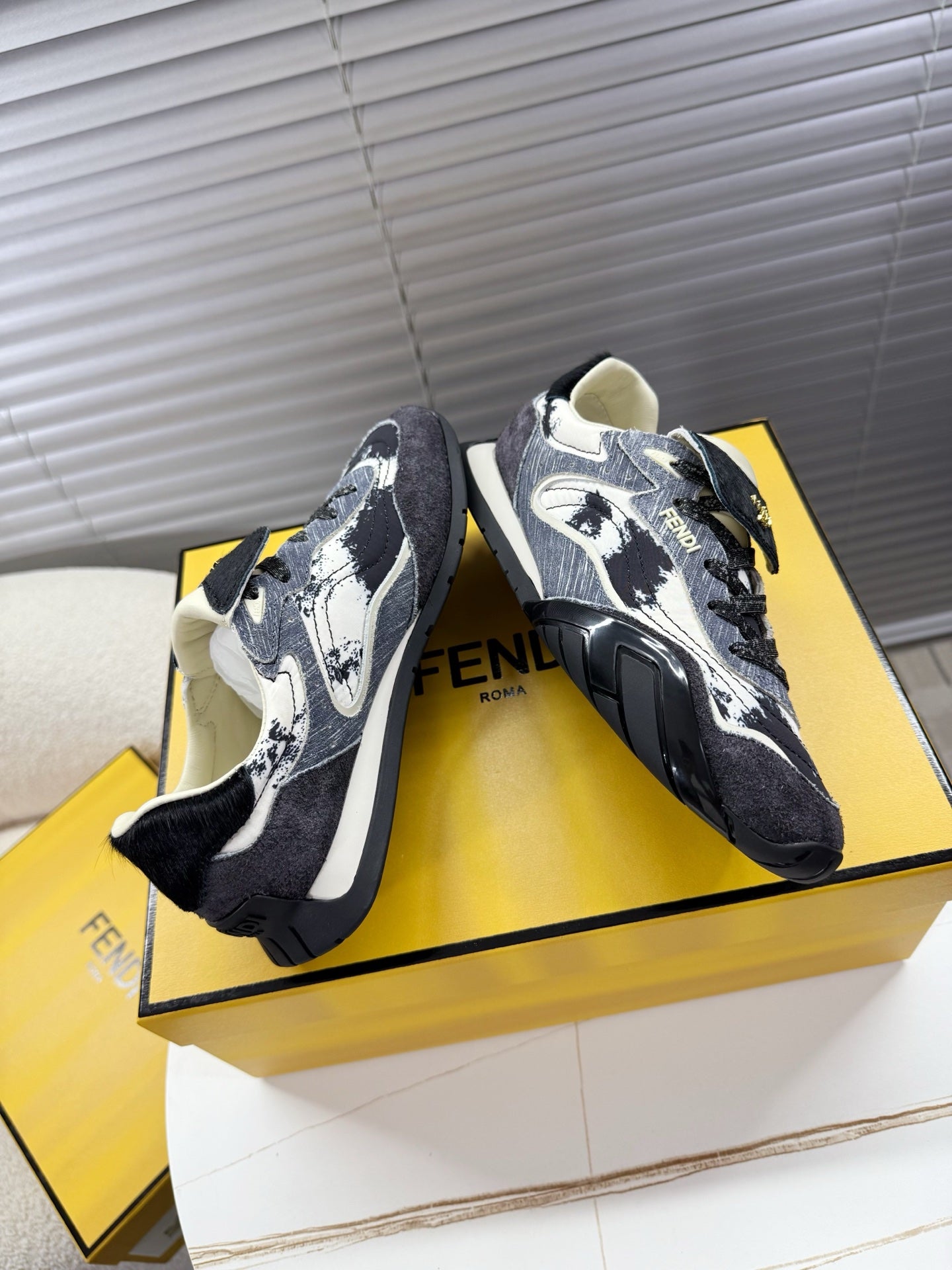 Fendi unisex sneakers, angled pair with dark fabric, white speckled pattern and laces