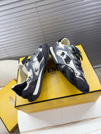 Fendi lace-up sneakers, black and white splatter, cream lining, opposite side angle.
