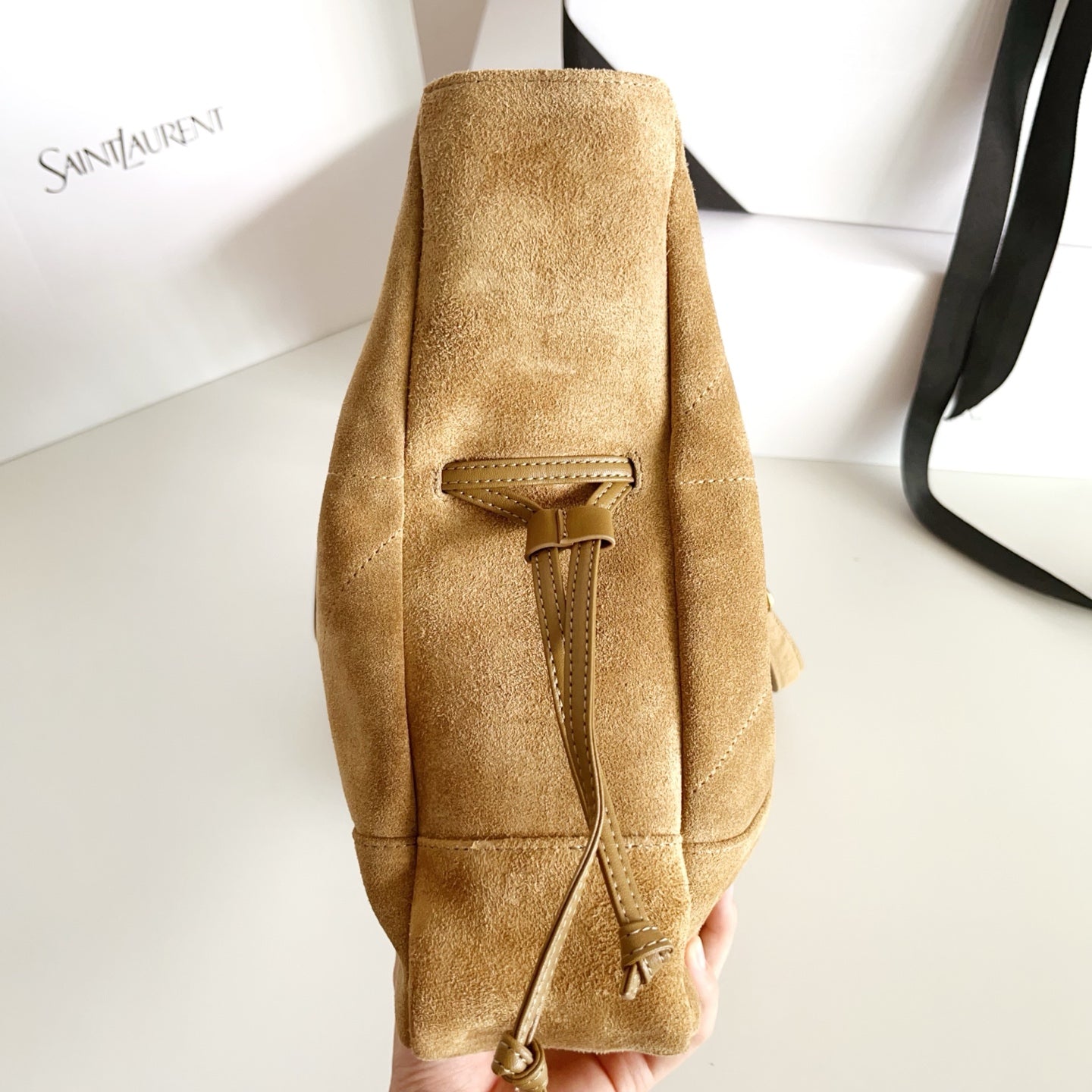 Tan suede tote bag with back pocket panel and tied leather lace detail