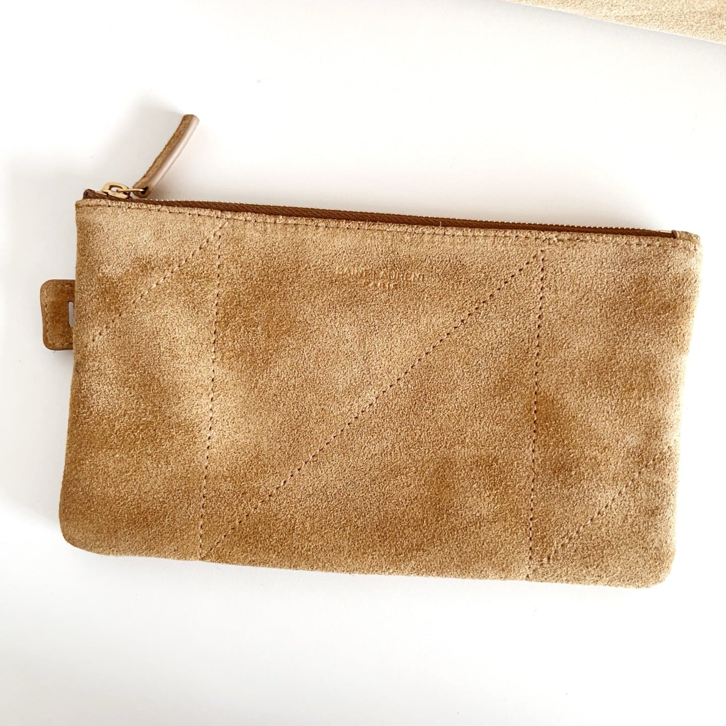Tan suede zip pouch with stitched quilted panels and small leather pull tab