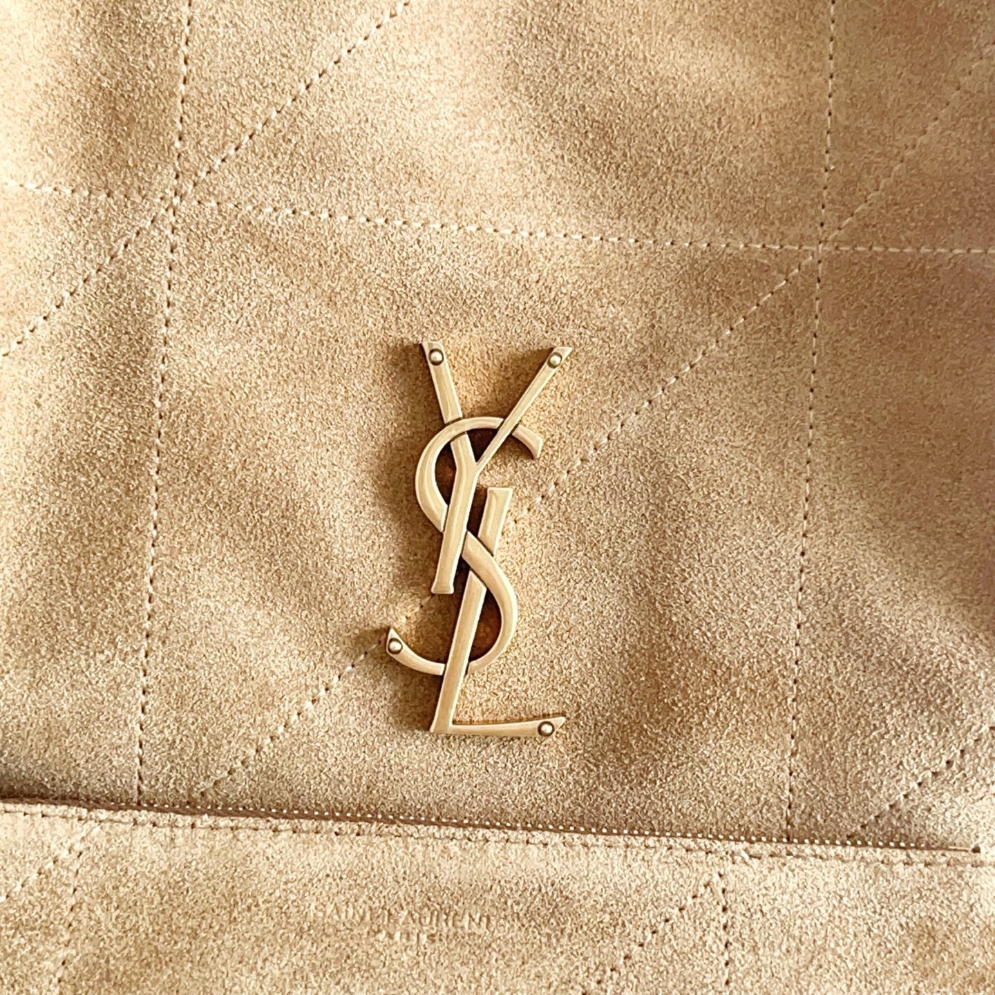 YSL logo hardware on tan suede tote bag front panel