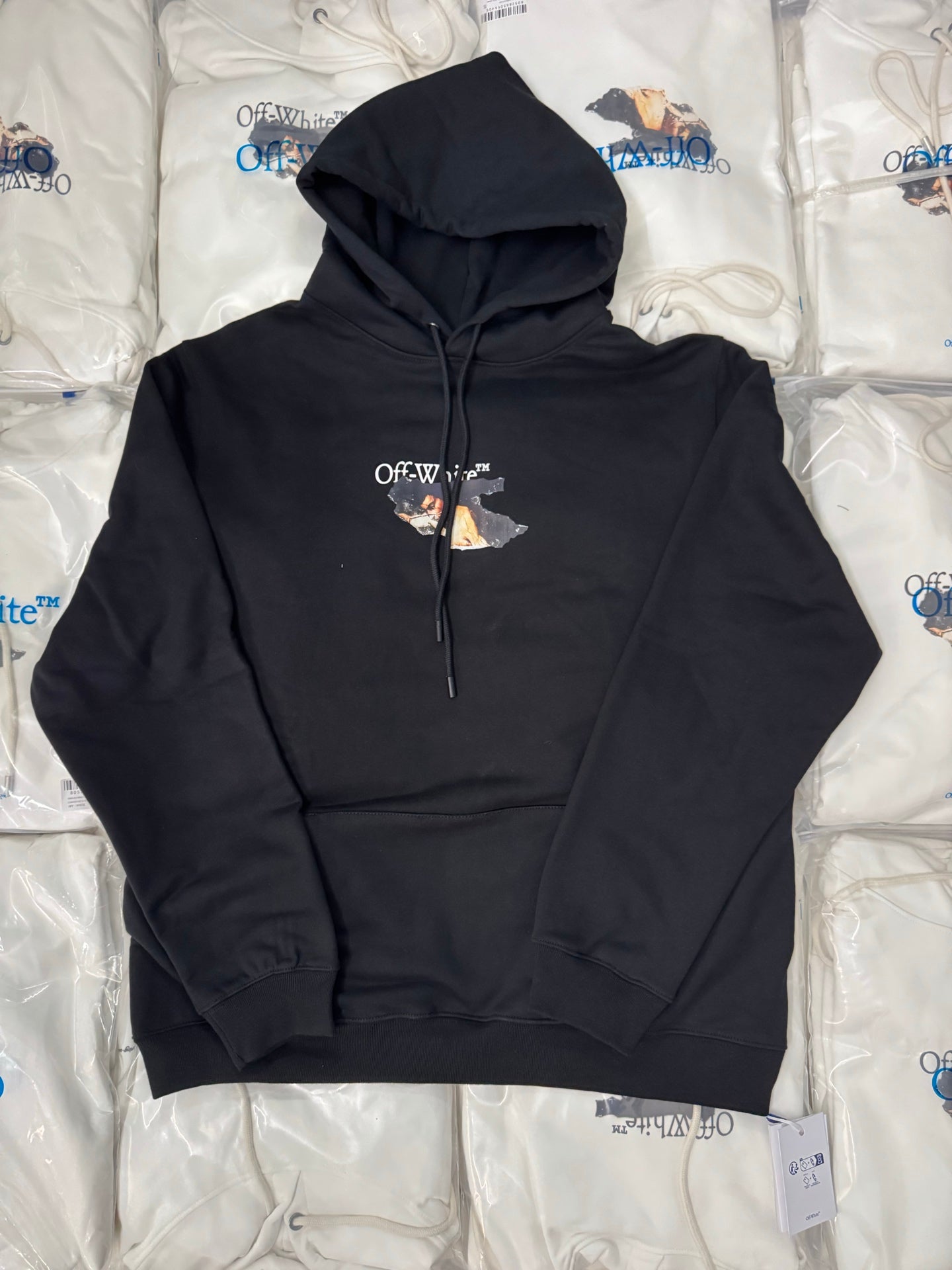 Black pullover hoodie with adjustable drawstring hood and small chest graphic logo