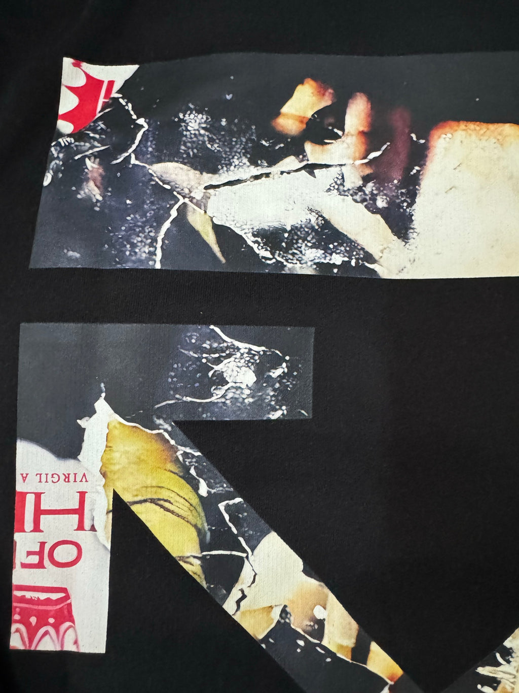 Black hoodie back print detail with photo-like graphics and white/gray shapes