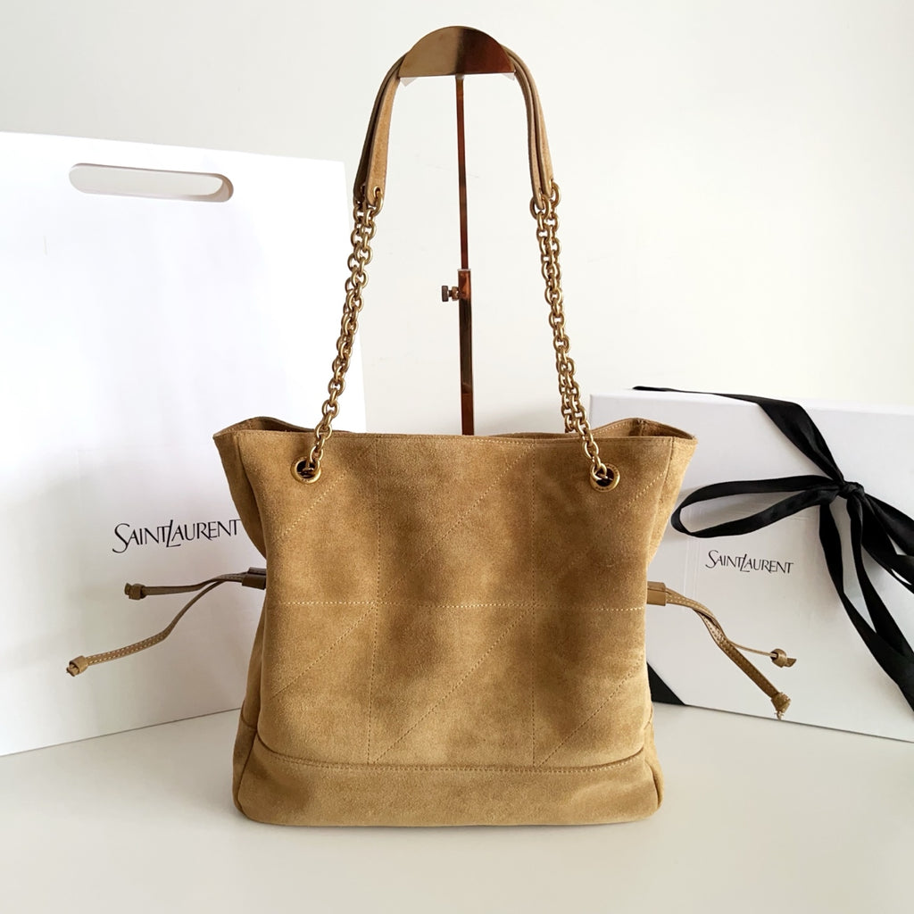 Tan suede tote bag with chain handles and drawstring-style side details