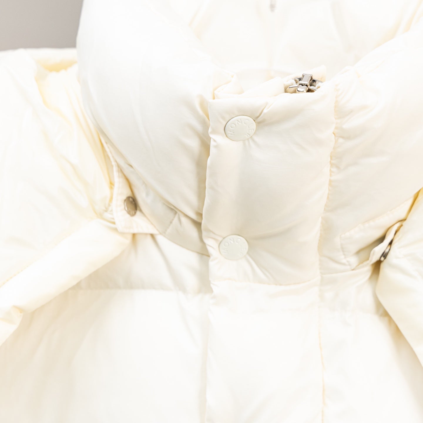 Moncler white puffer jacket close-up of snap placket and quilted panels