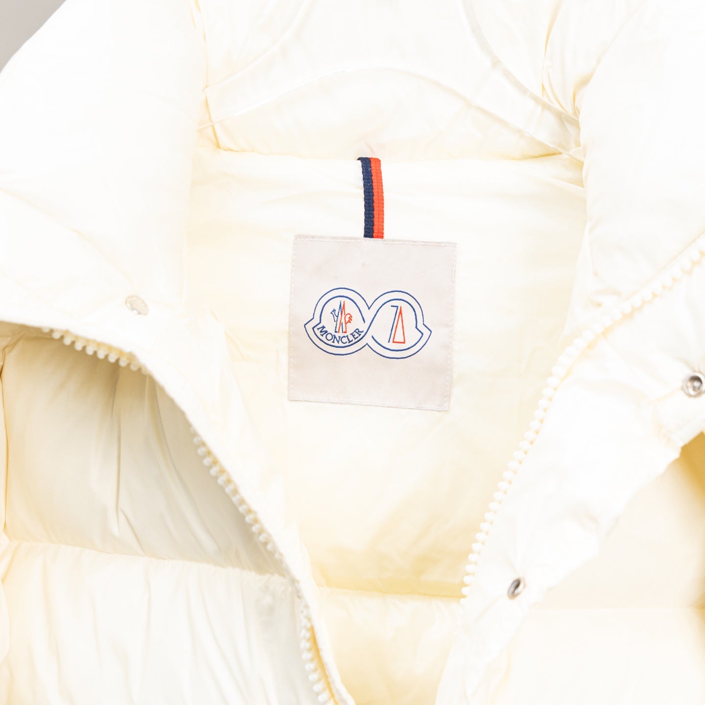 Moncler white puffer jacket chest logo patch with striped trim detail